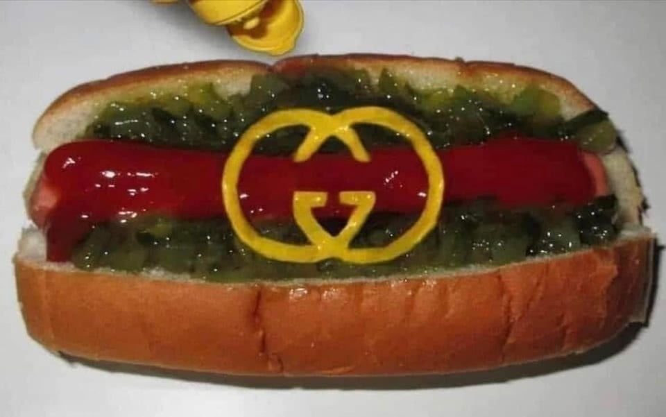 person put the logo of gucci in mustard on their hot dog