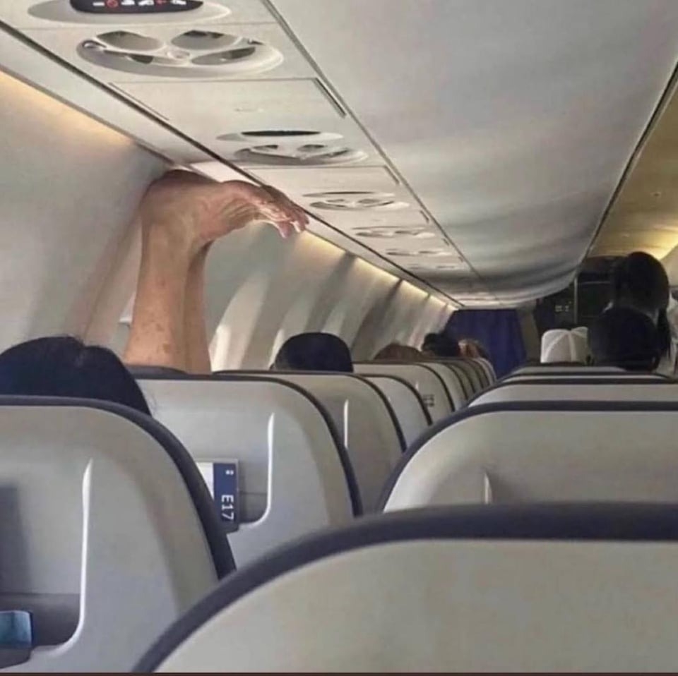 person with their feet on the top while their on a plane