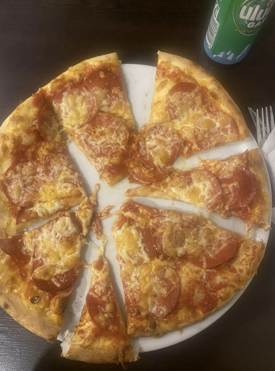 A pizza pie with slices cut in all different shapes and sizes