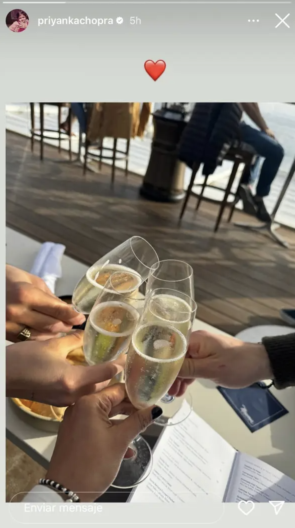 A screenshot of an IG story featuring hands cheersing glasses of champagne