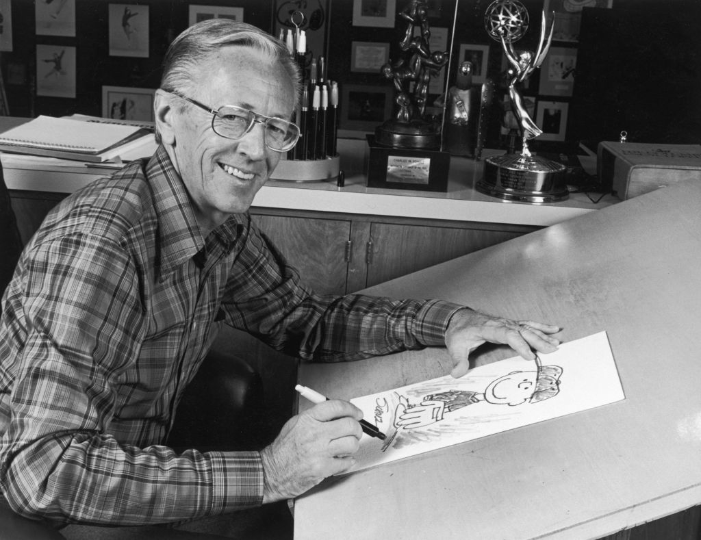Charles Schulz sketching a comic