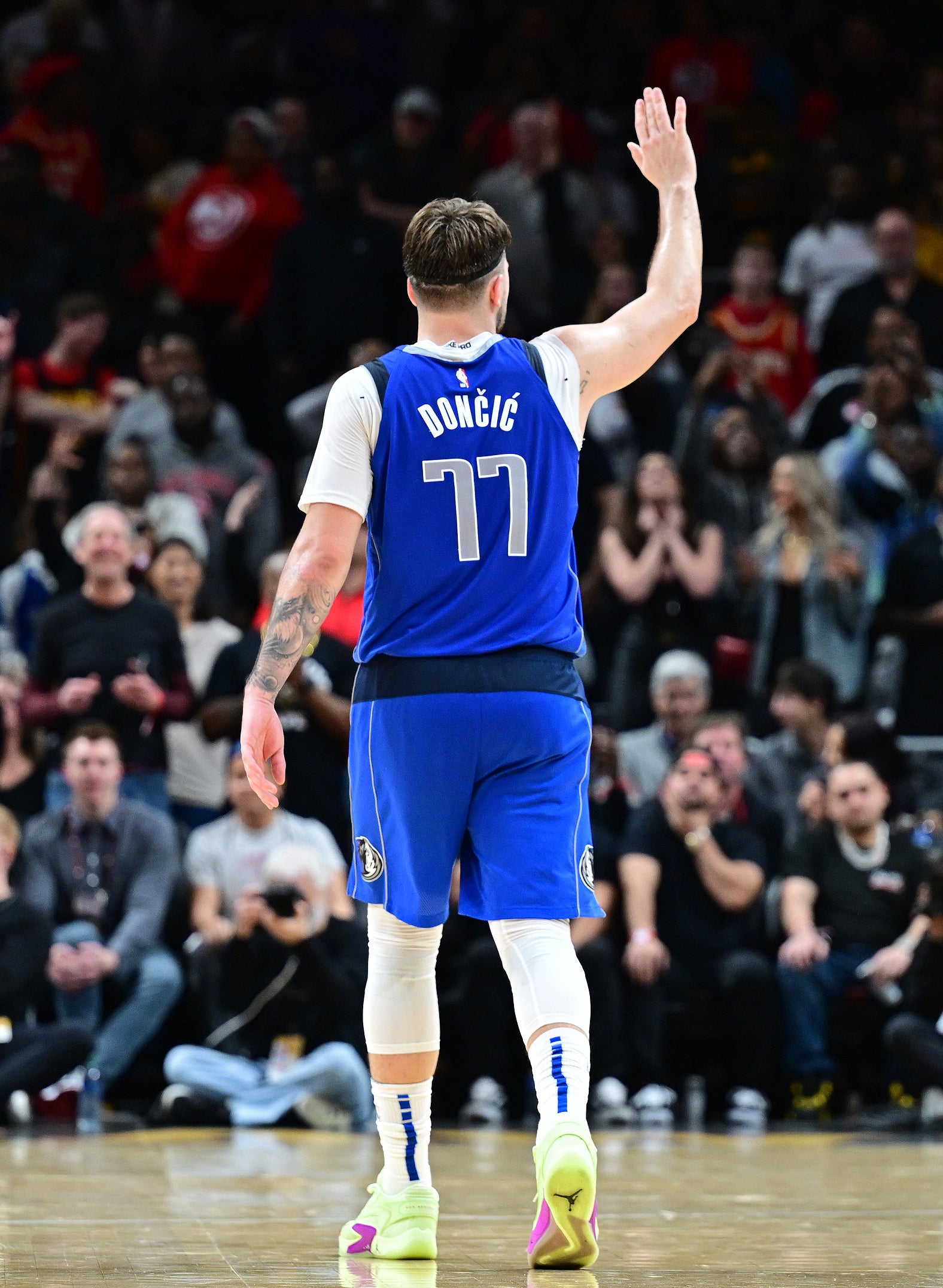 Luka Doncic #77 of the Dallas Mavericks waves to fans during the game against the Atlanta Hawks on January 26, 2024 at State Farm Arena in Atlanta, Georgia.
