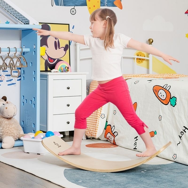 child plays on a balance board
