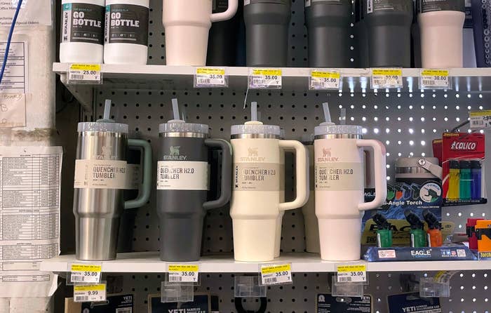 A store shelf full of large Stanley tumblers
