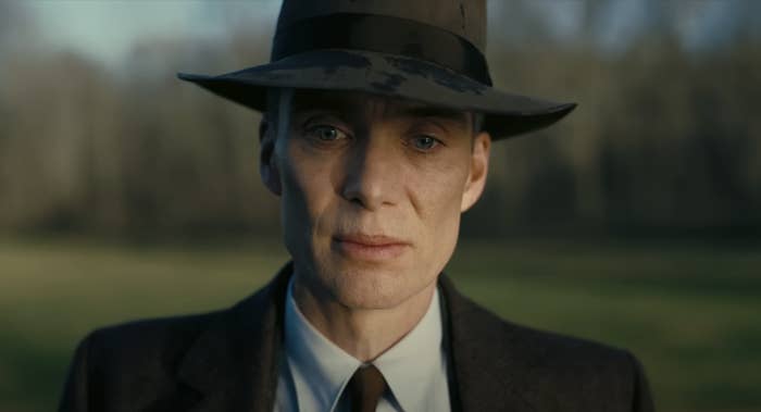 Close-up of Cillian in a suit and tie and brimmed hat as Oppenheimer