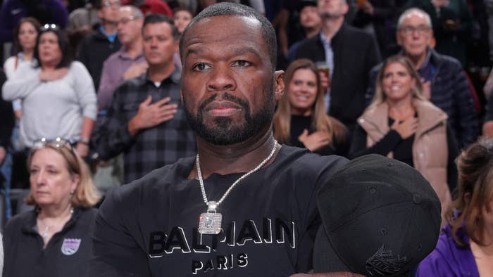50 cent takes his hat off at a game