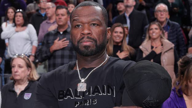 50 cent takes his hat off at a game