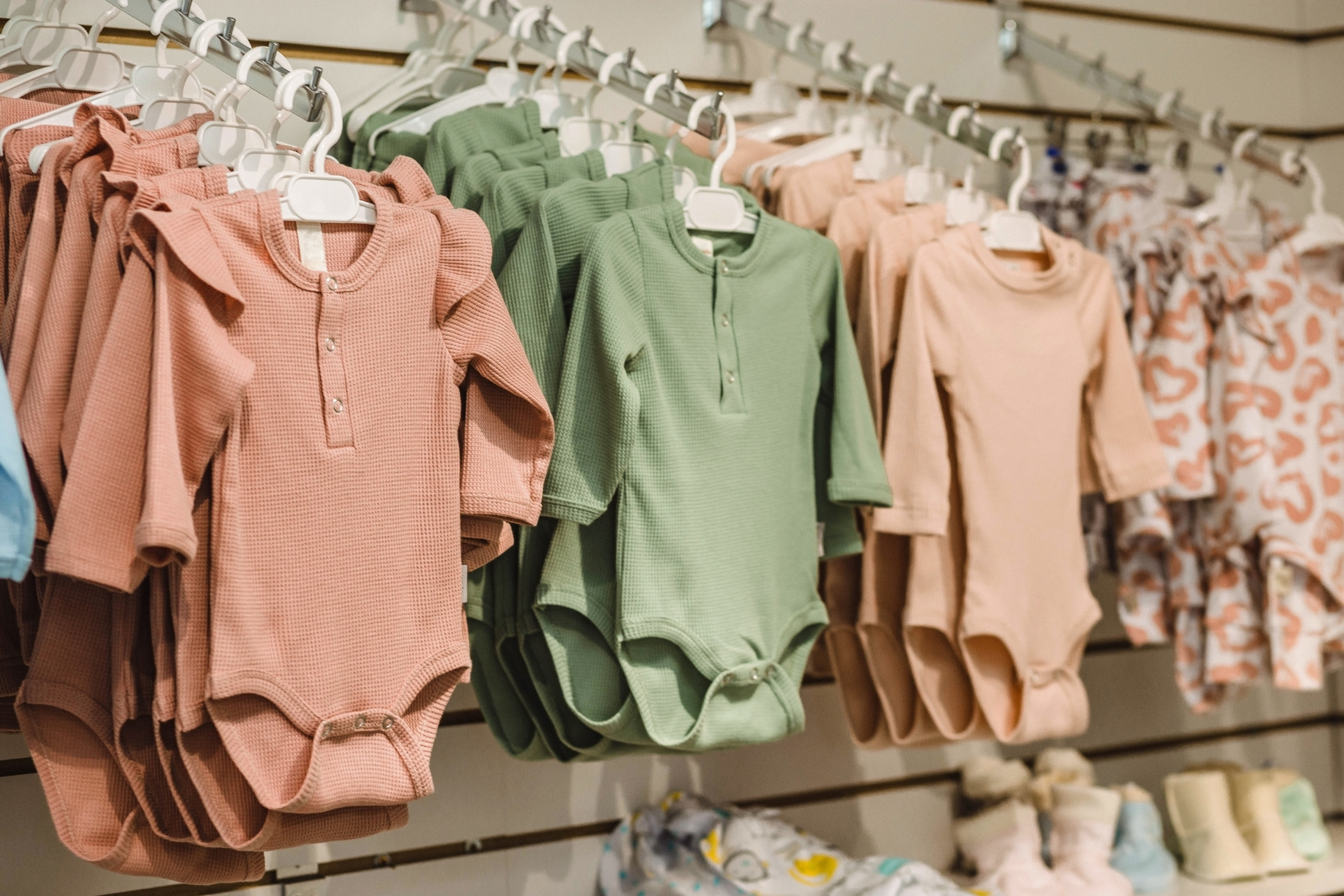 Baby clothing on hangars in store