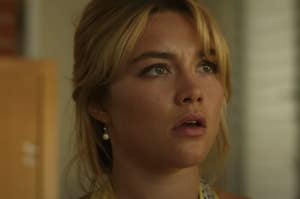 Florence Pugh as seen in "Don't Worry Darling" with a concerned expression on her face