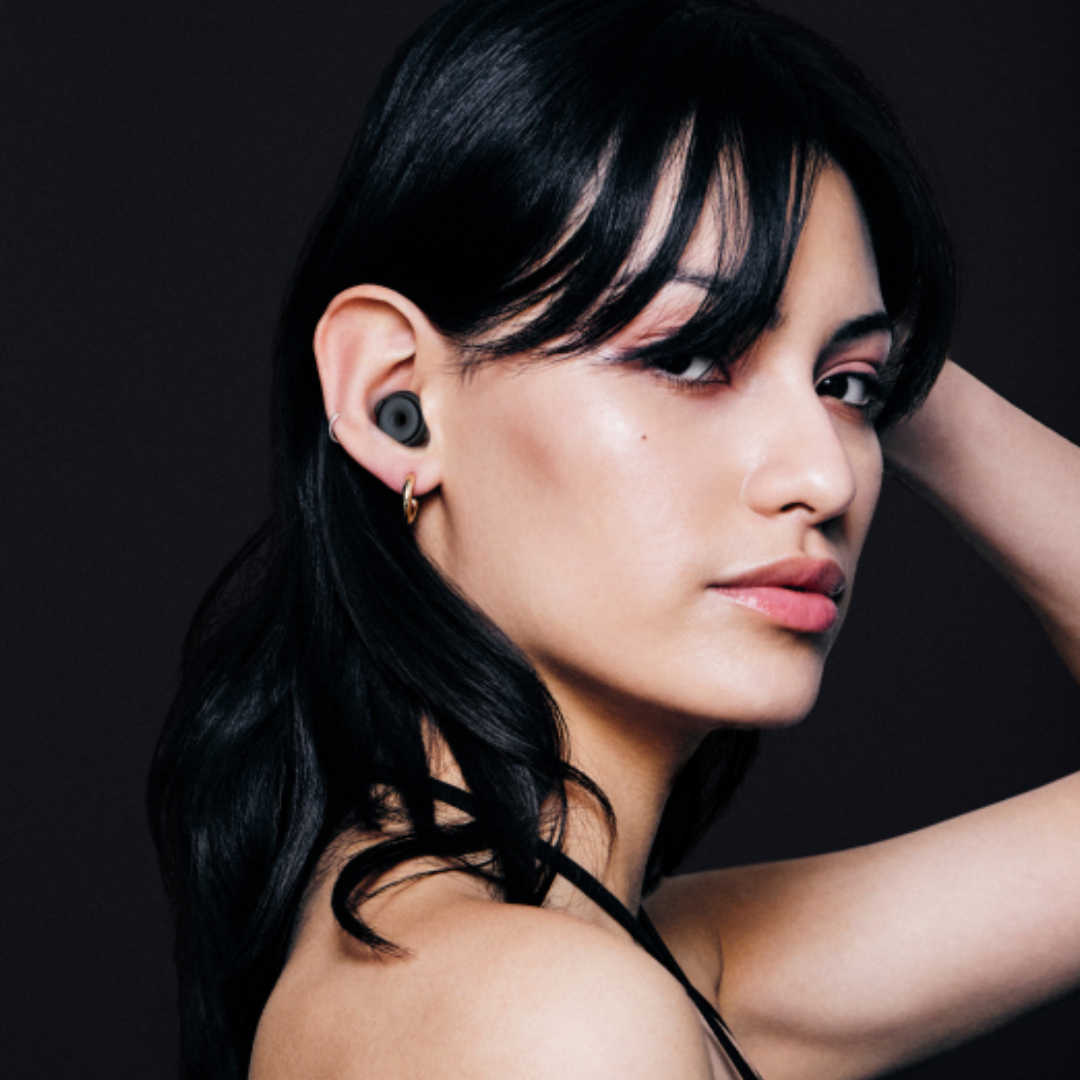 A woman modeling earplugs