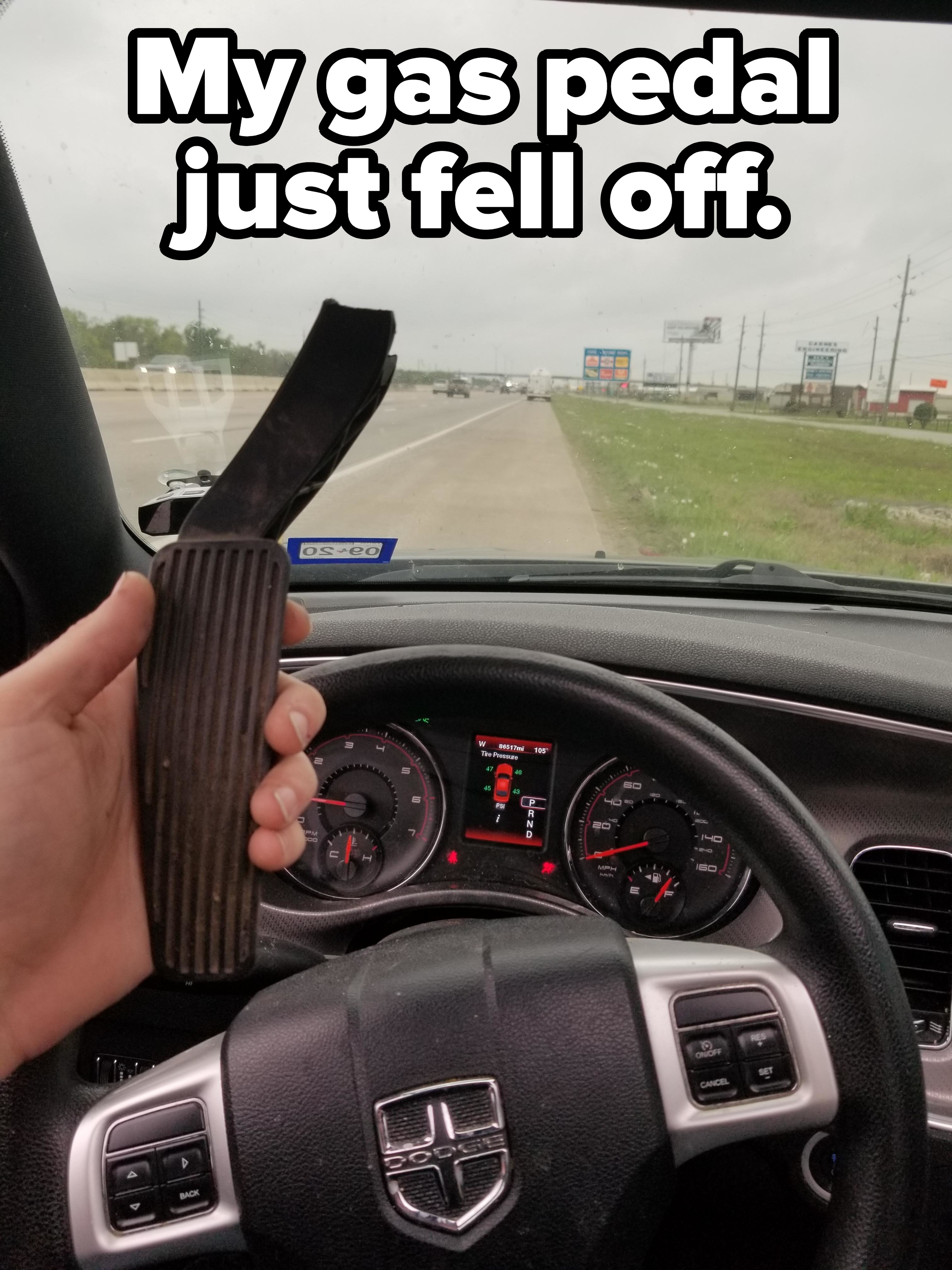 &quot;My gas pedal just fell off&quot;: A person holding up a gas pedal in the driver&#x27;s seat
