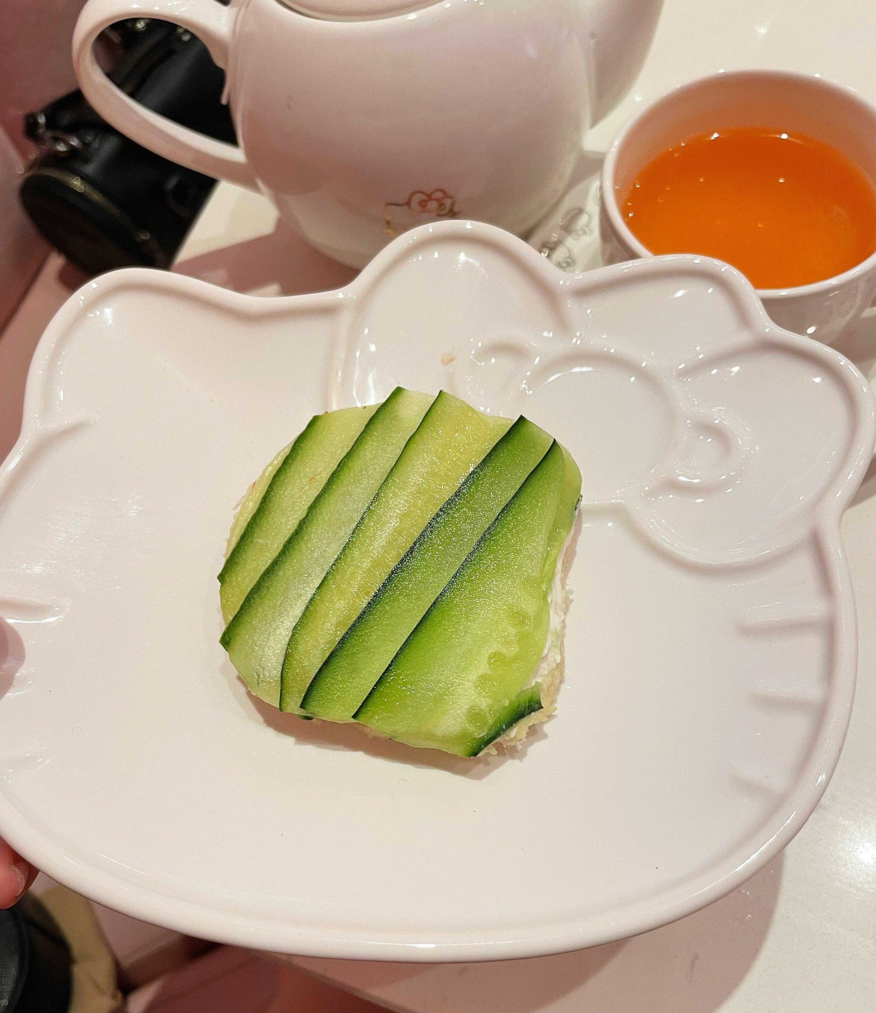 A cucumber sandwich is on a plate