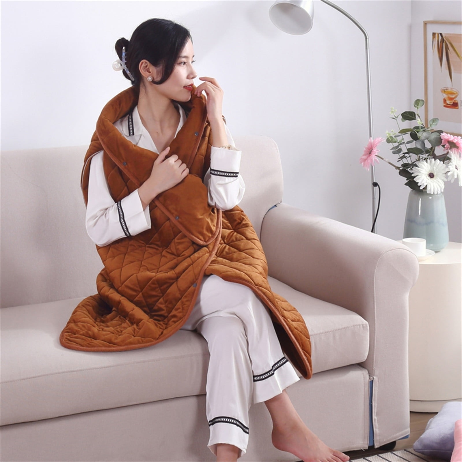 a model wearing the caramel colored blanket shawl