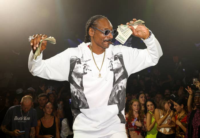 Snoop Dogg performs with money in his hands