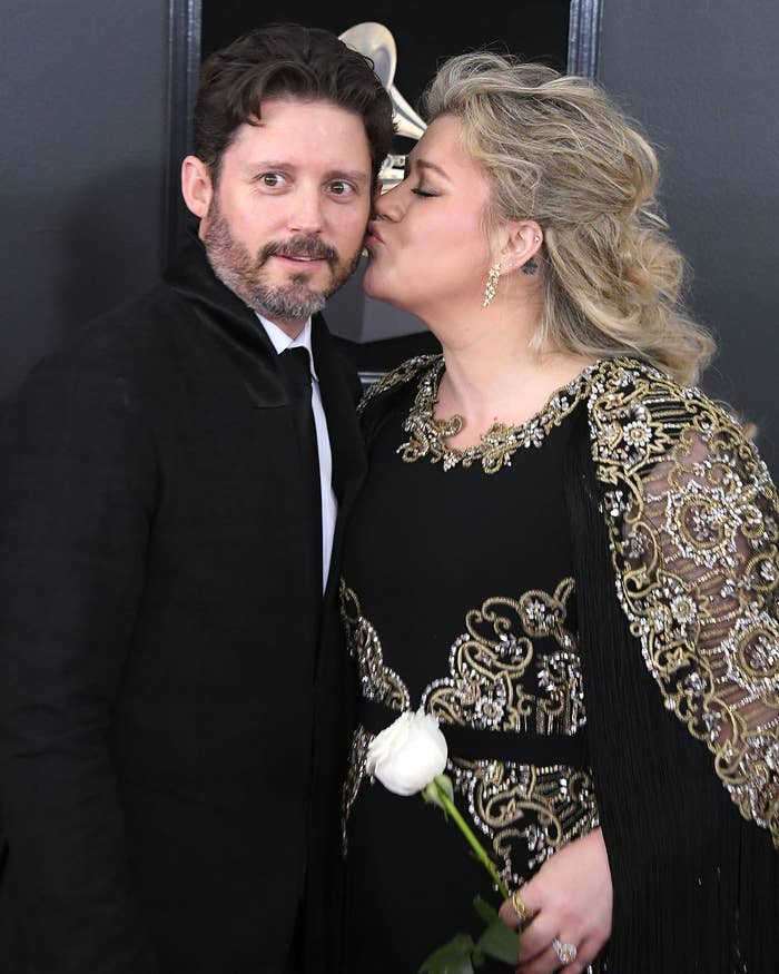 Kelly kisses Brandon on the cheek at a red carpet event