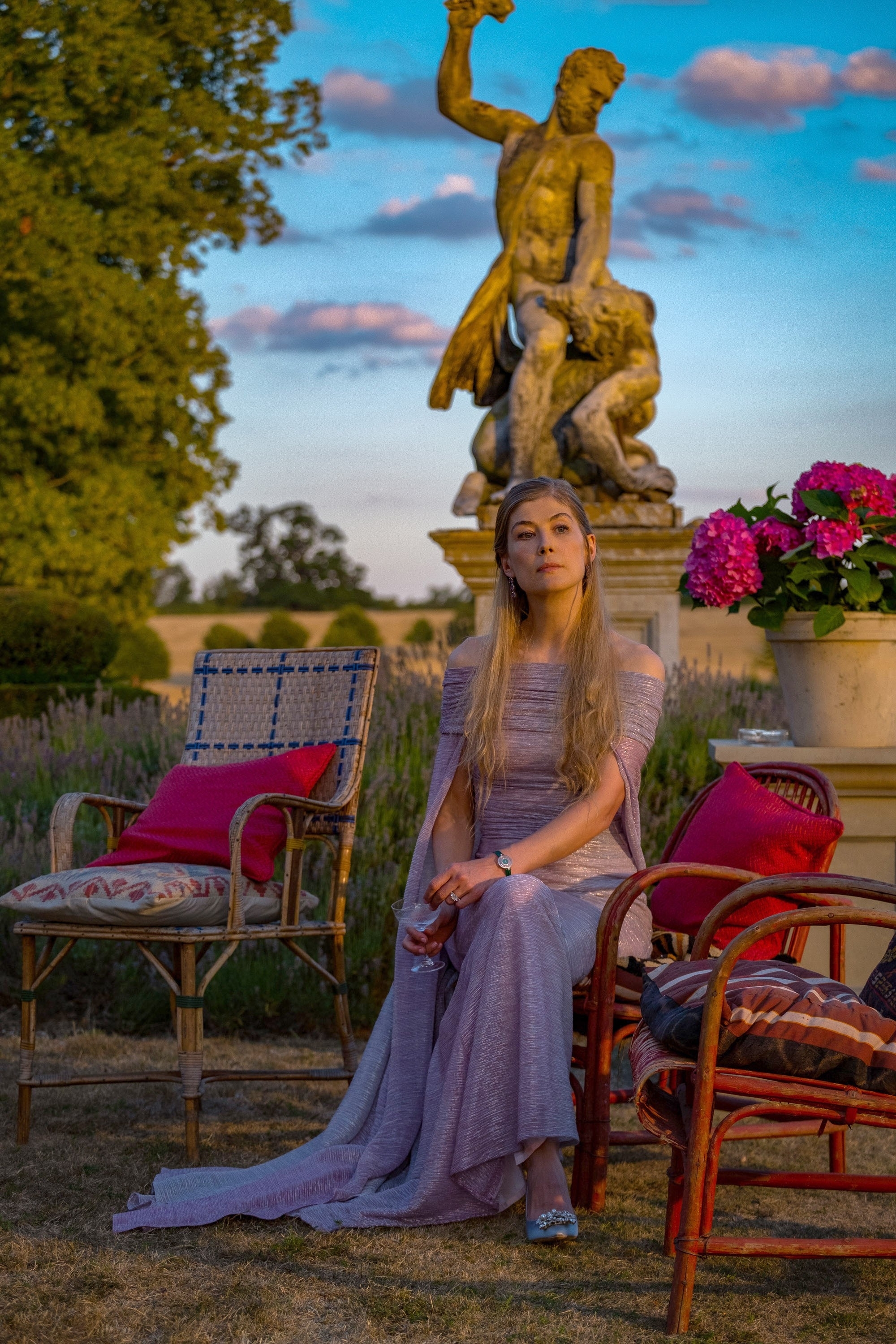Rosamund as Elspeth sitting in front of a statue