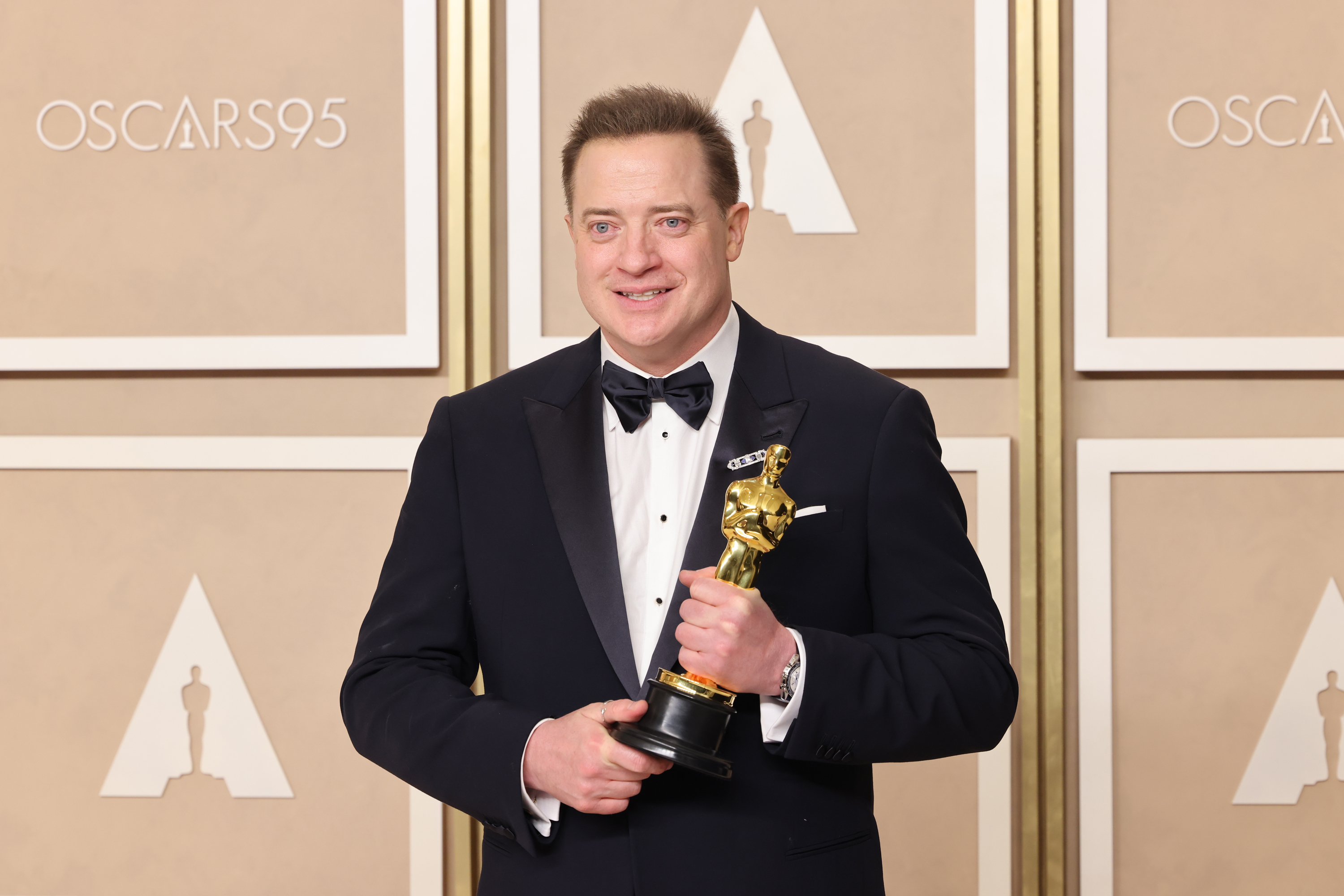 Closeup of Brendan Fraser holding his Oscar