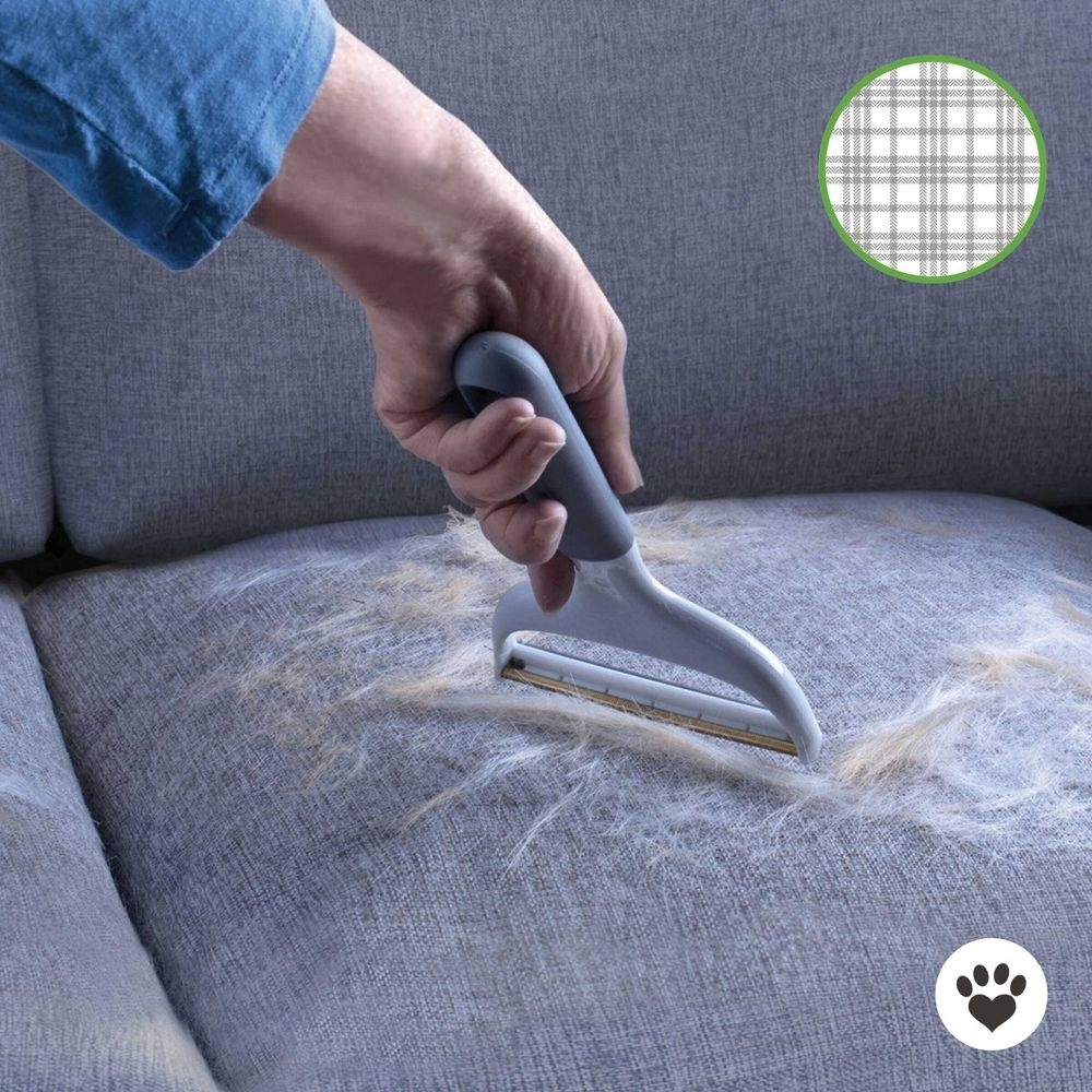the remover being used on the sofa to remove pet hair
