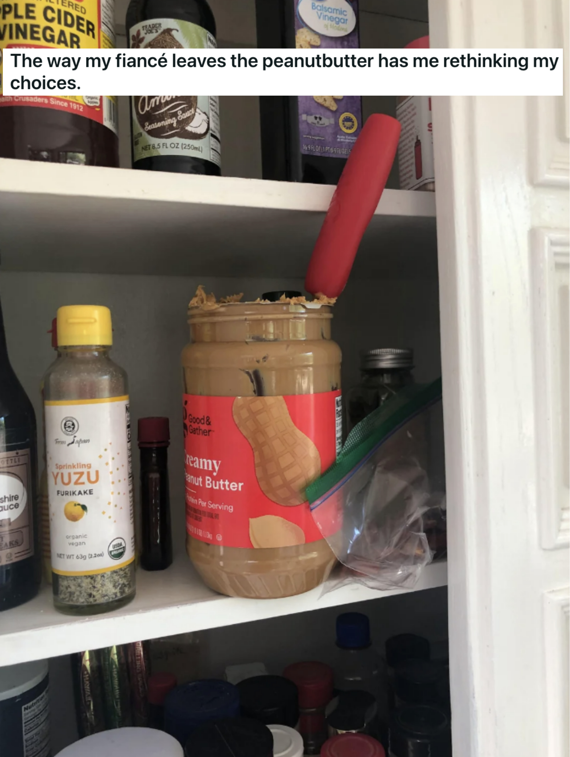 an opened jar of peanut butter in the pantry