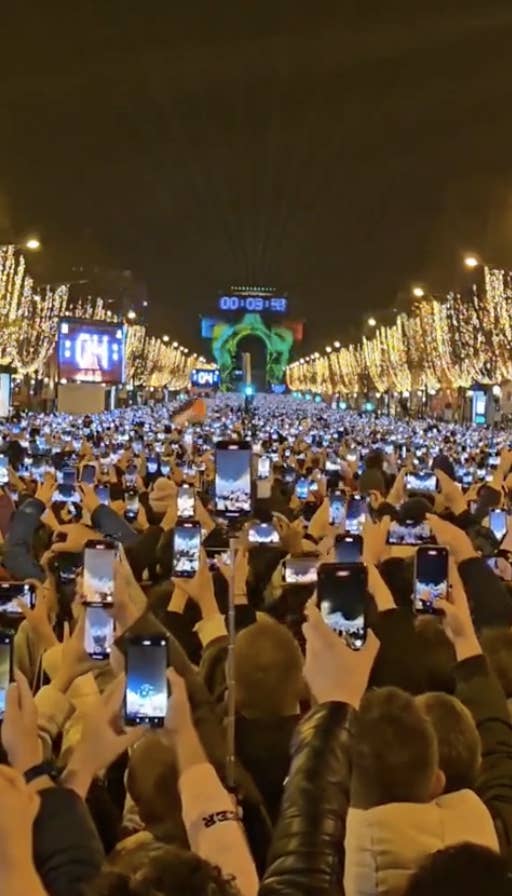 a bunch of people filming New Year&#x27;s on their phones