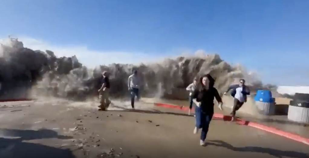 people running from a wave