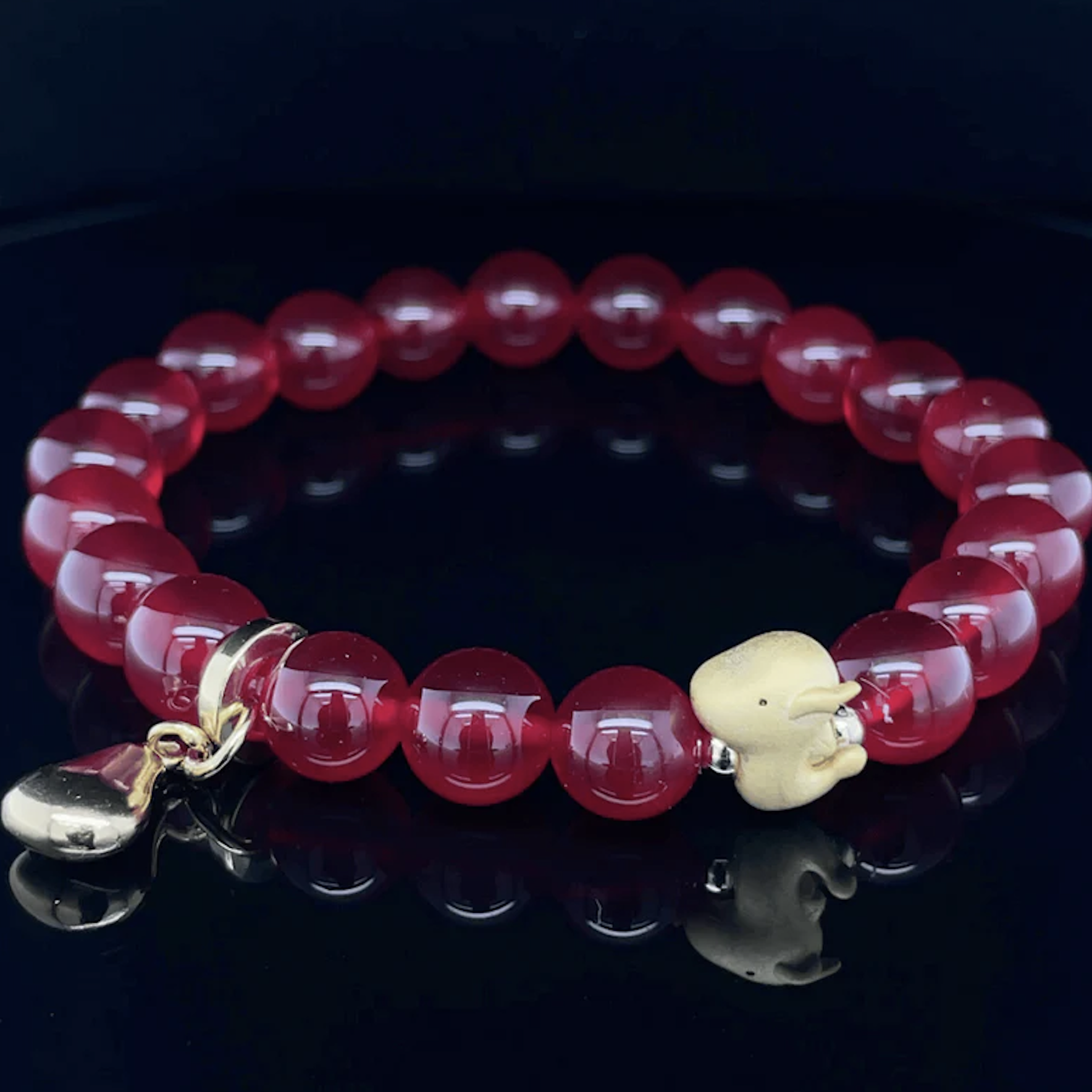 Red beaded bracelet with dragon charm
