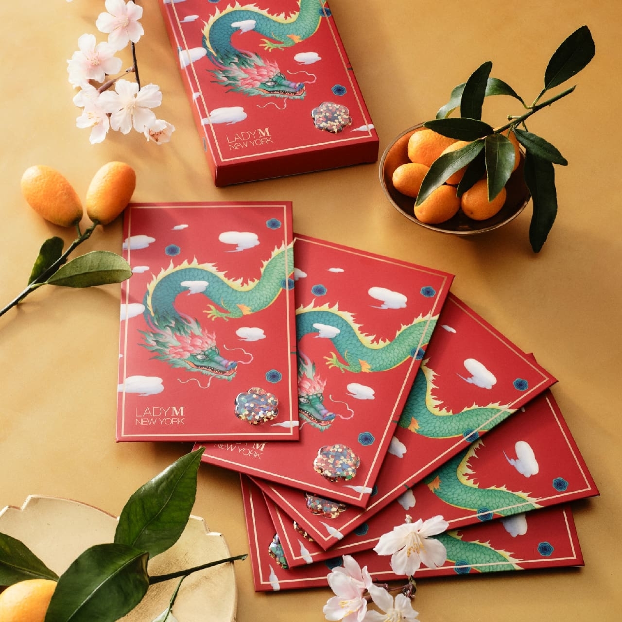 Five dragon themed red envelopes with flower shaped confetti shaker