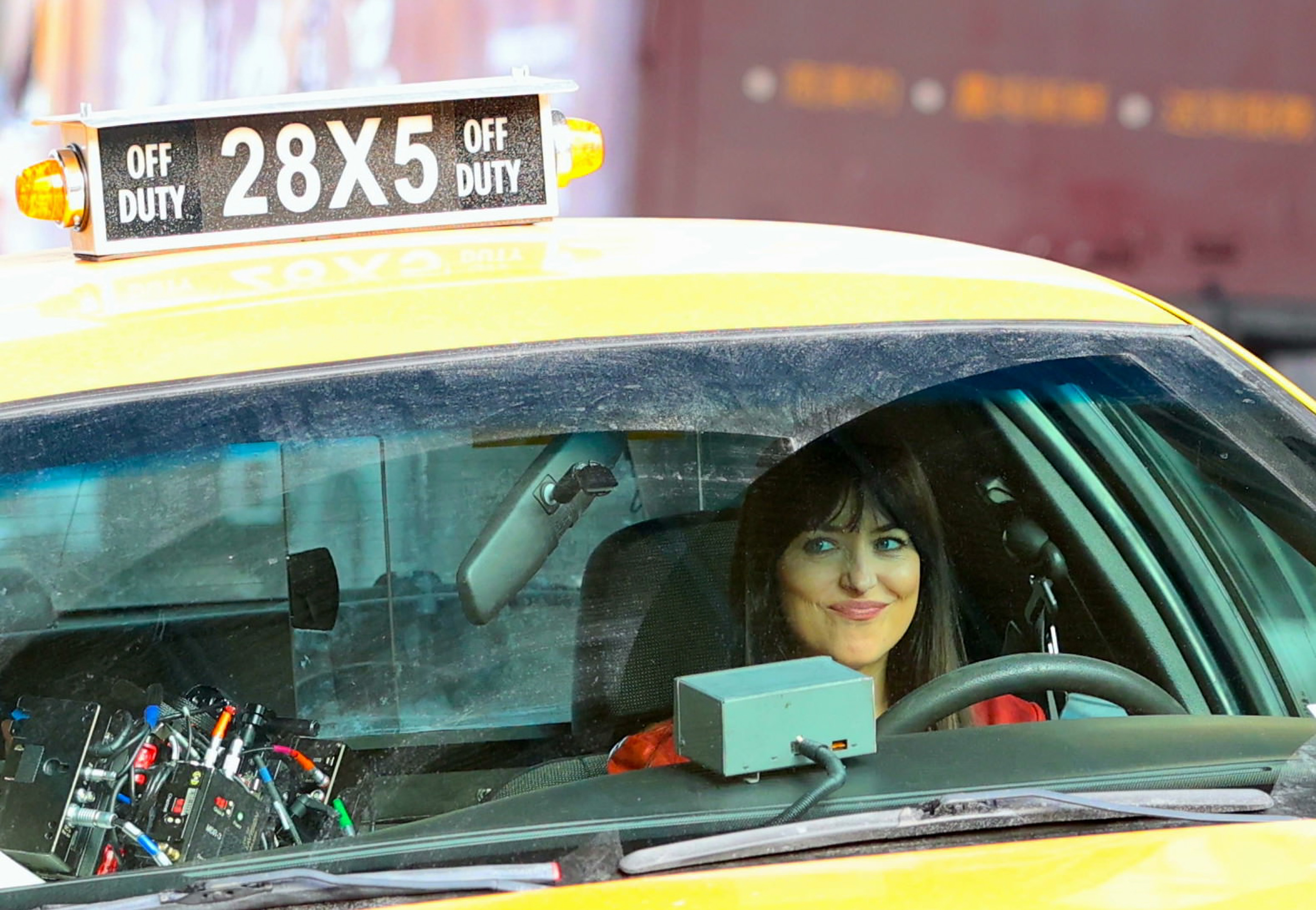Dakota in the driver&#x27;s side of a taxi