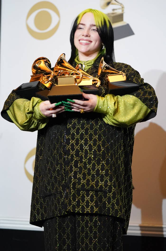 Billie Eilish holding her Grammys