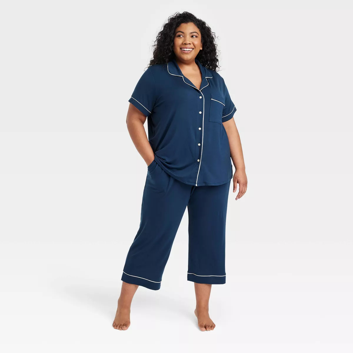 A model wearing the pajama set in the color Navy Blue