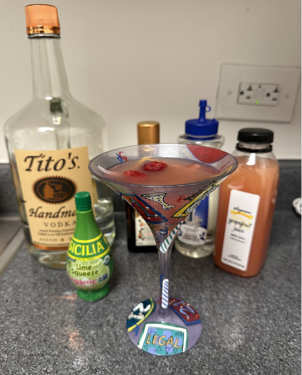 a martini glass in front of the drink ingredients