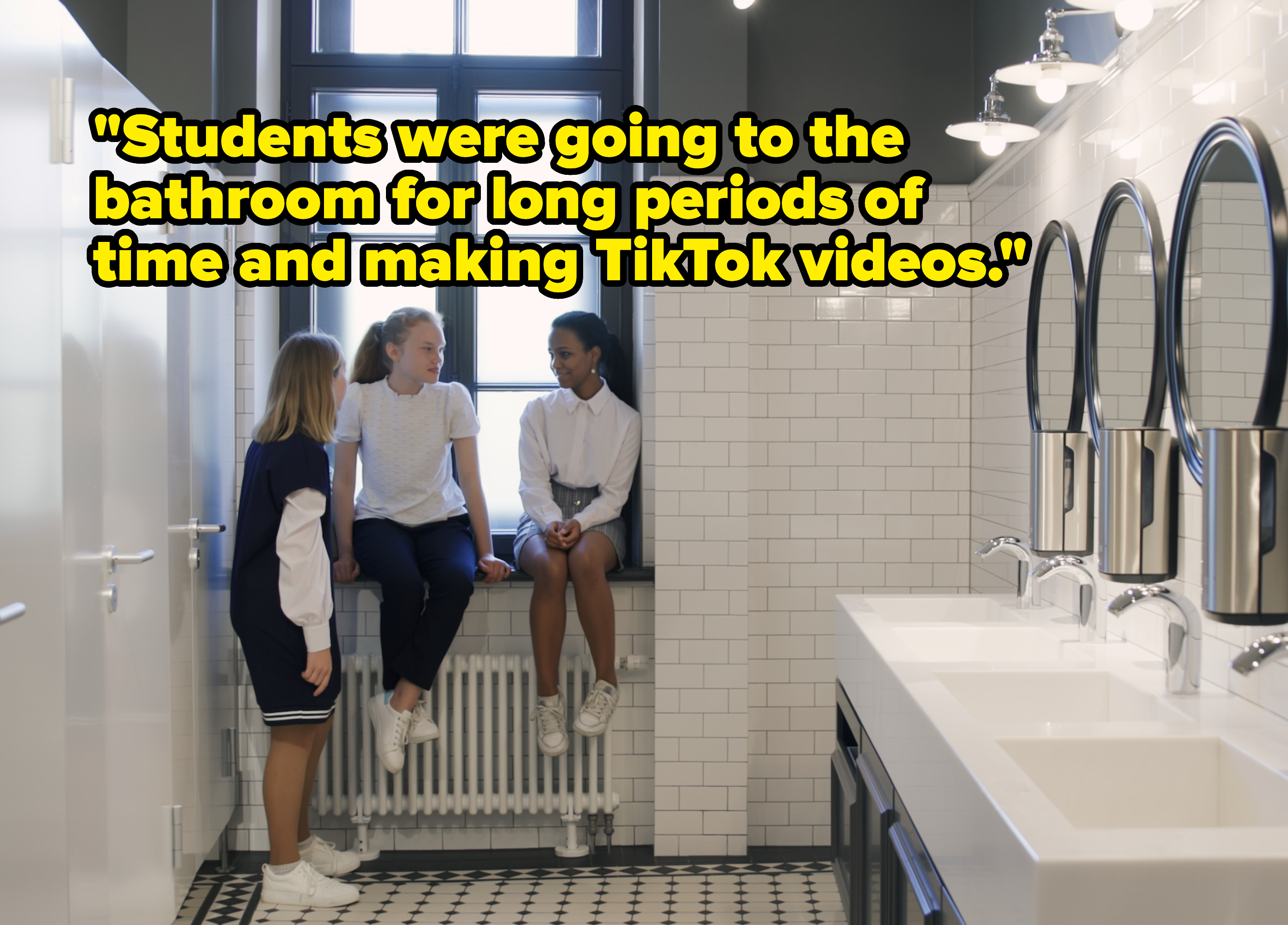 Young girls in school bathroom with caption &quot;Students were going to the bathroom for long periods of time and making TikTok videos&quot;