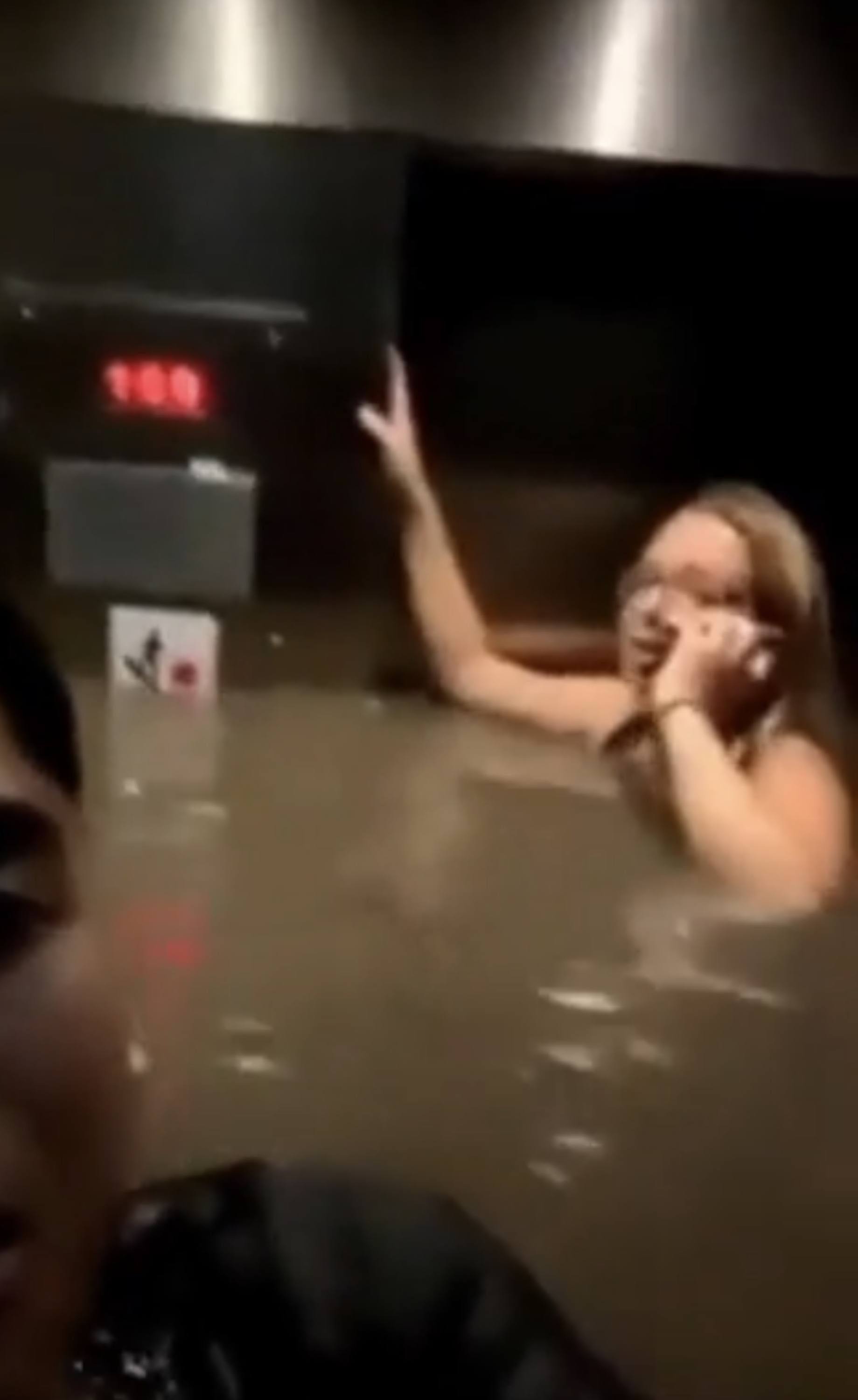 People in a flooded elevator