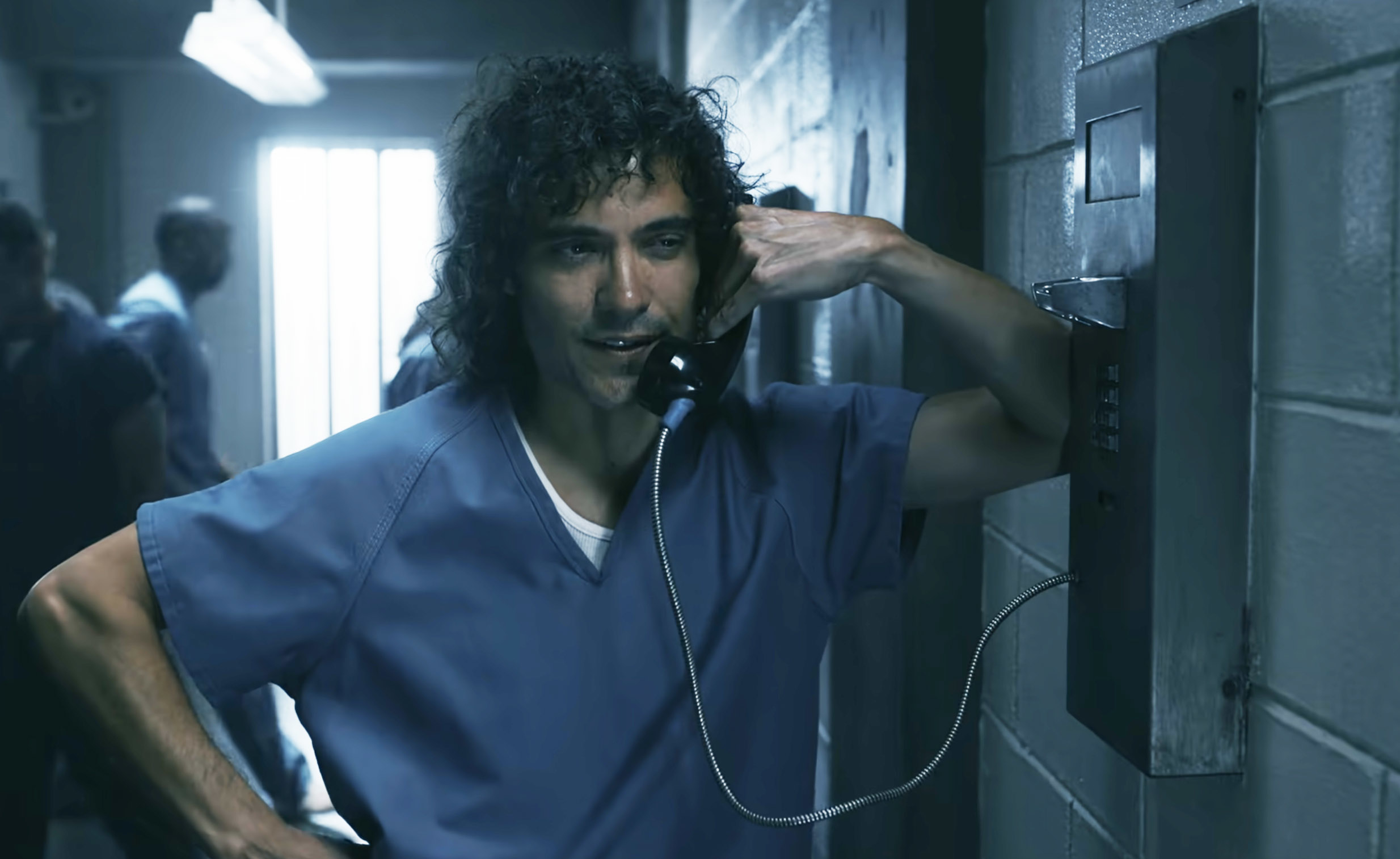 Rivi on the phone in prison in a scene from the show