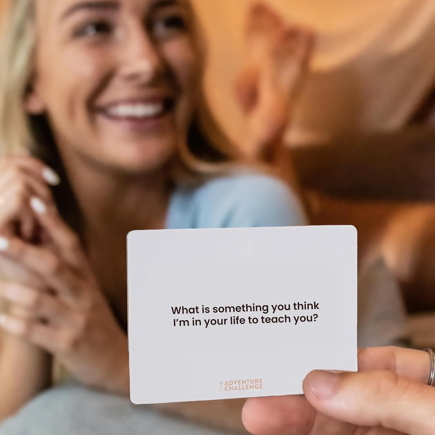 a person holding up a card with another person in the background