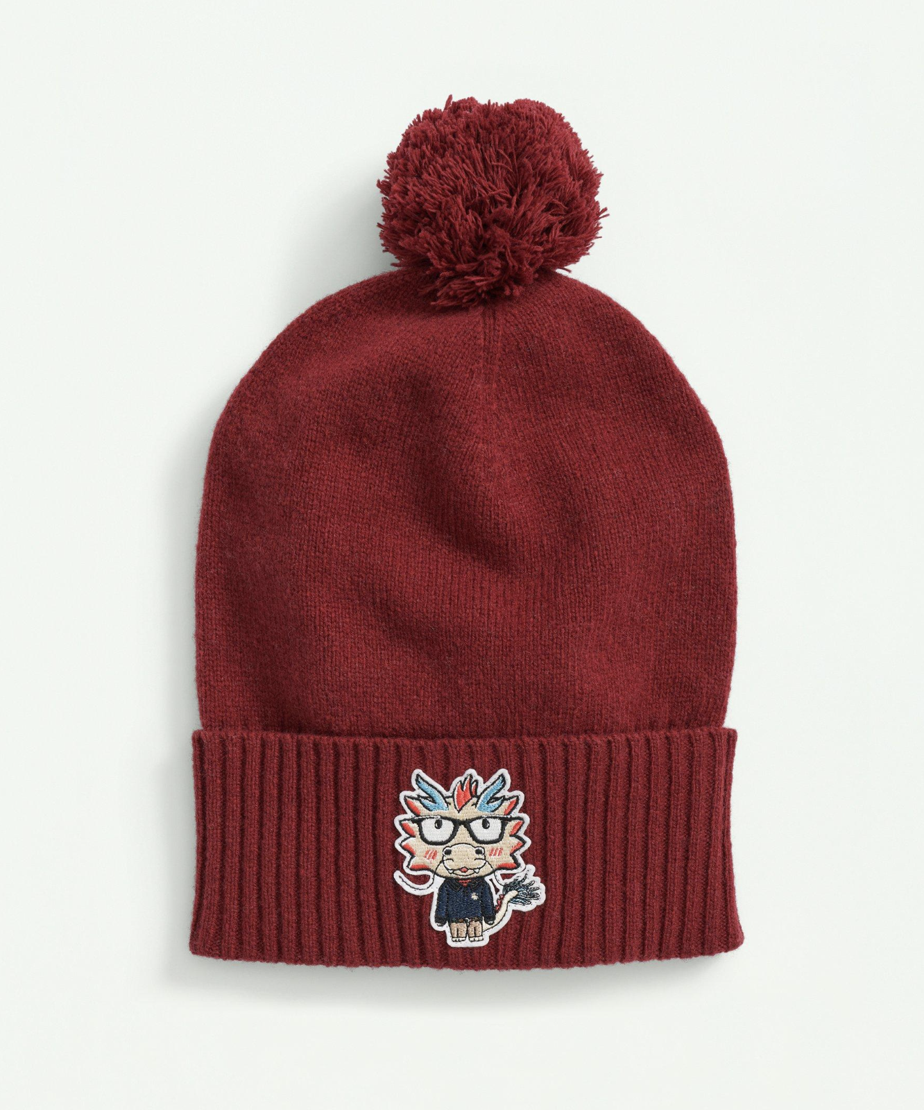 Red pom hat with dragon patch
