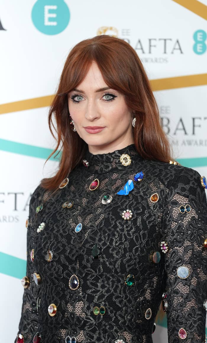 A closeup of Sophie on the red carpet in a long-sleeved outfit
