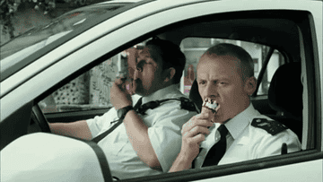 Two cops from &quot;Hot Fuzz&quot; eating ice cream in their car.