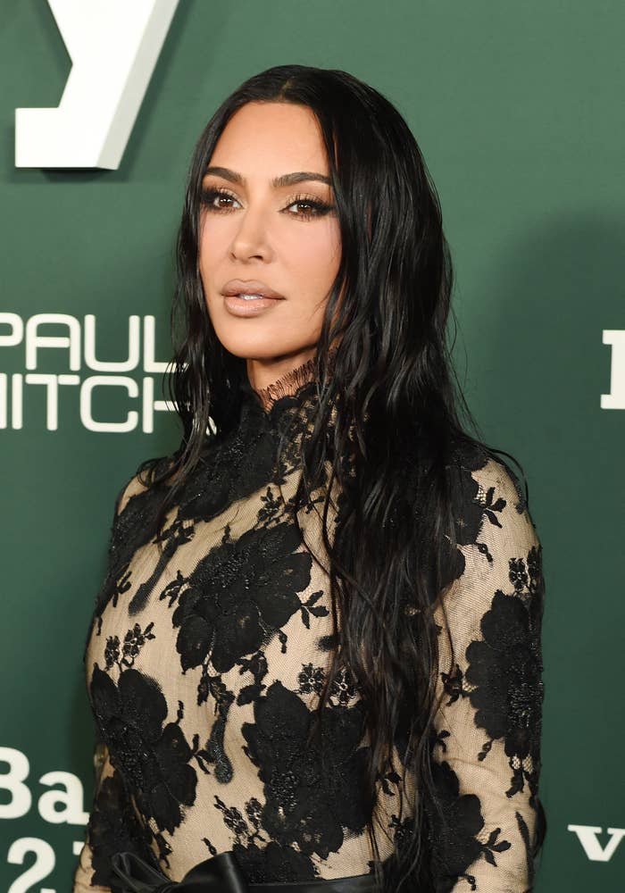 A closeup of Kim in a lace outfit
