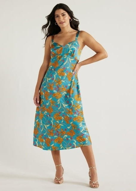 model wearing sleeveless blue orange flower-print slip dress