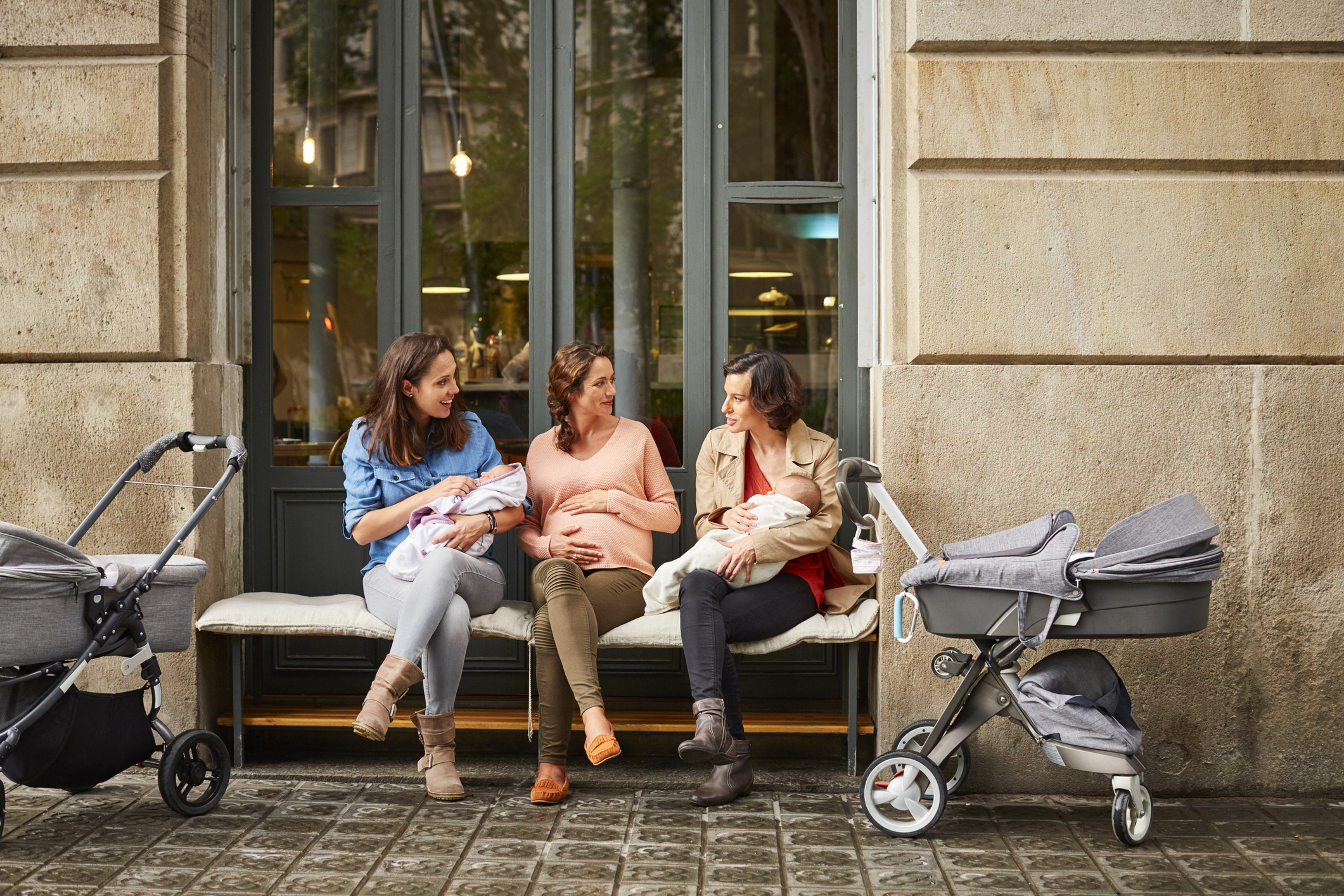 Women with babies on a bench