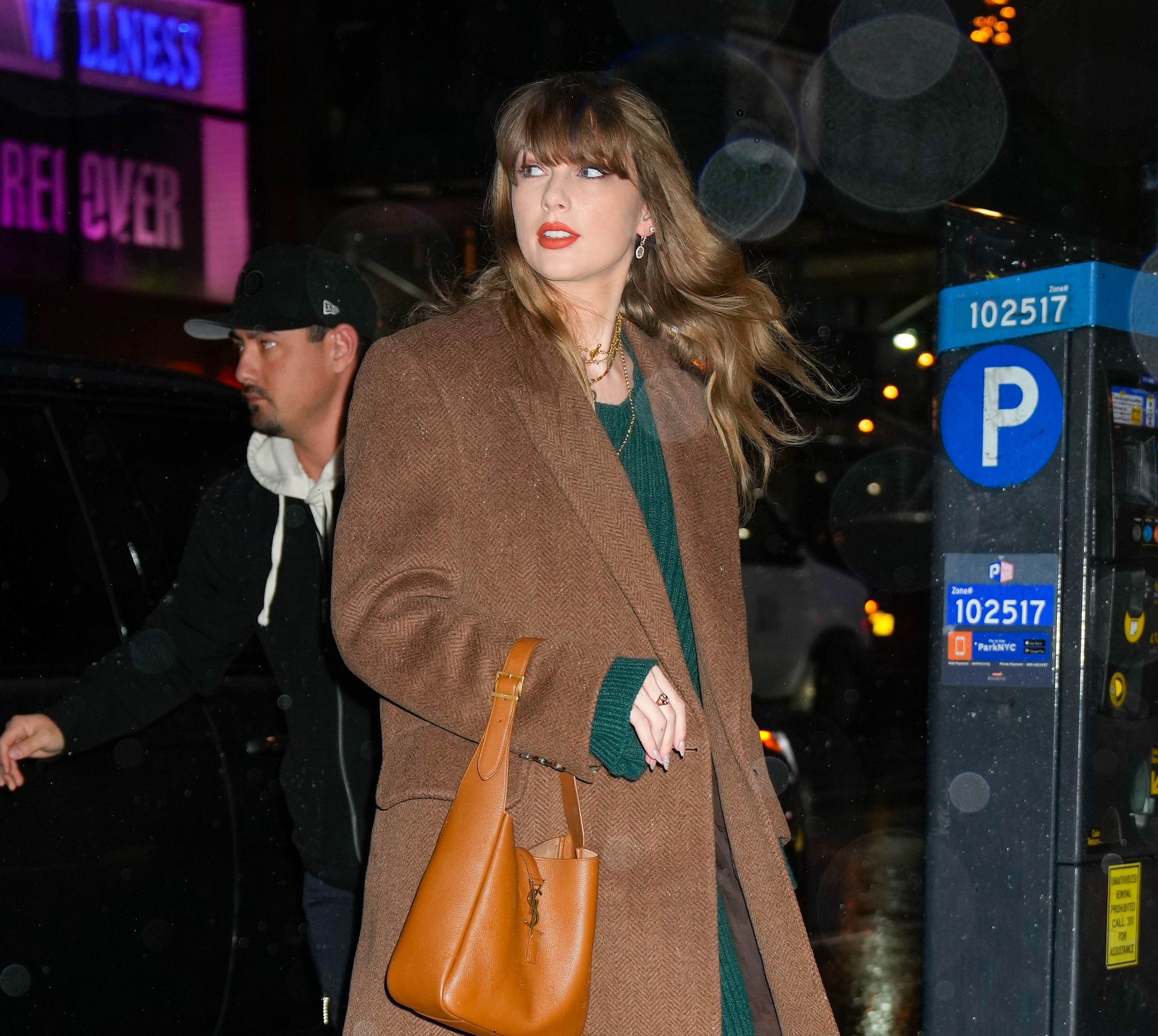 Close-up of Taylor outside wearing a coat