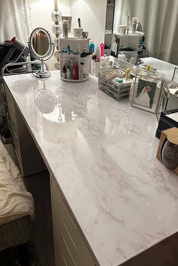 a reviewer's vanity covered in the marble adhesive
