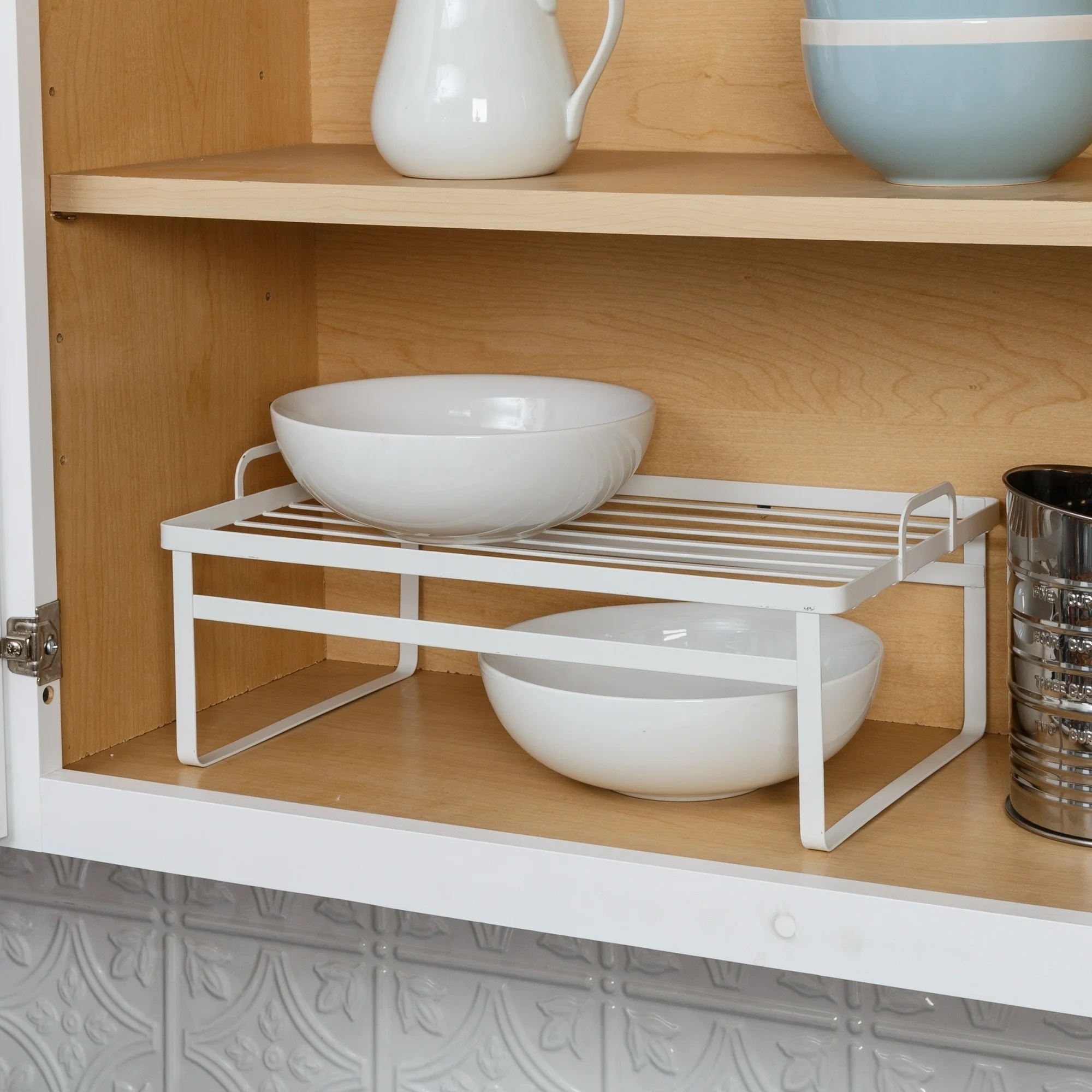 shelves in cabinet with bowls stacked above and below