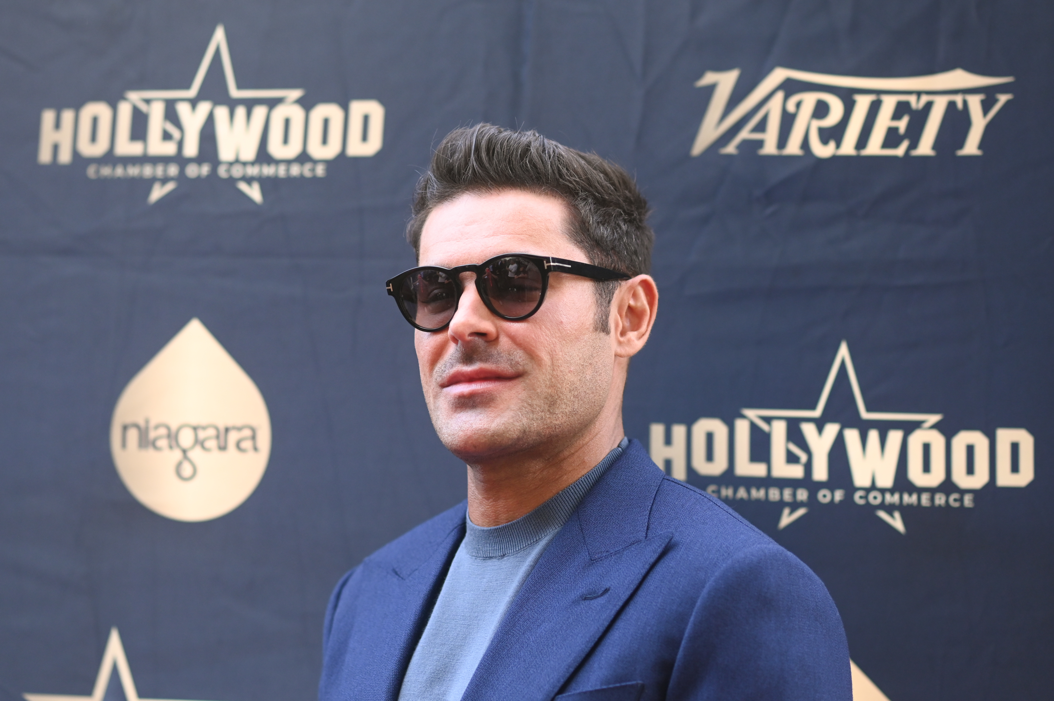 Close-up of Zac wearing sunglasses at a media event