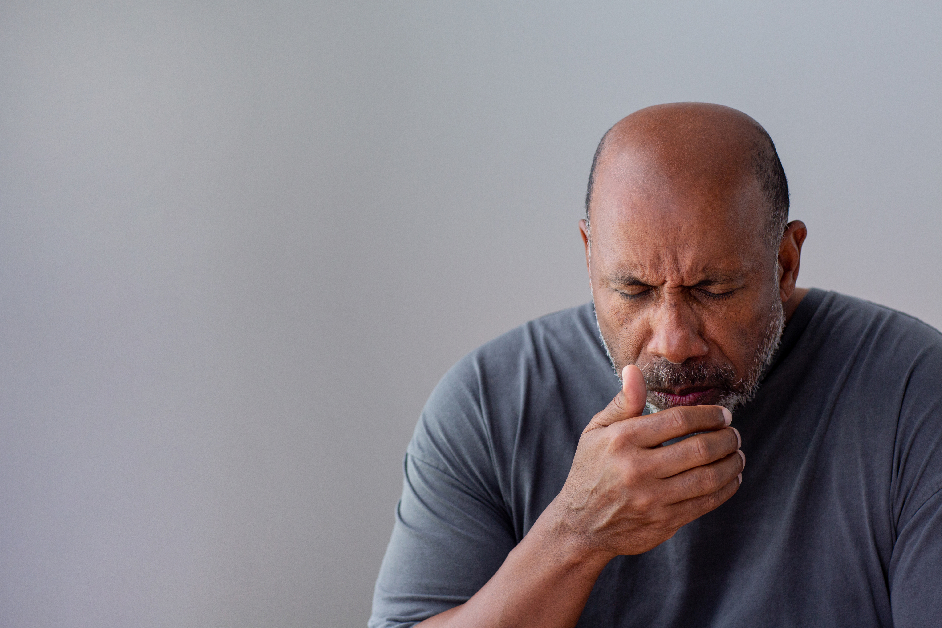 an older black man coughing