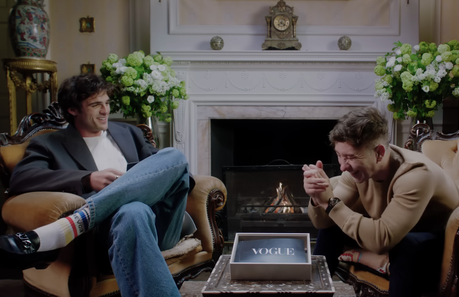 Jacob and Barry sitting and laughing together in front of a fireplace