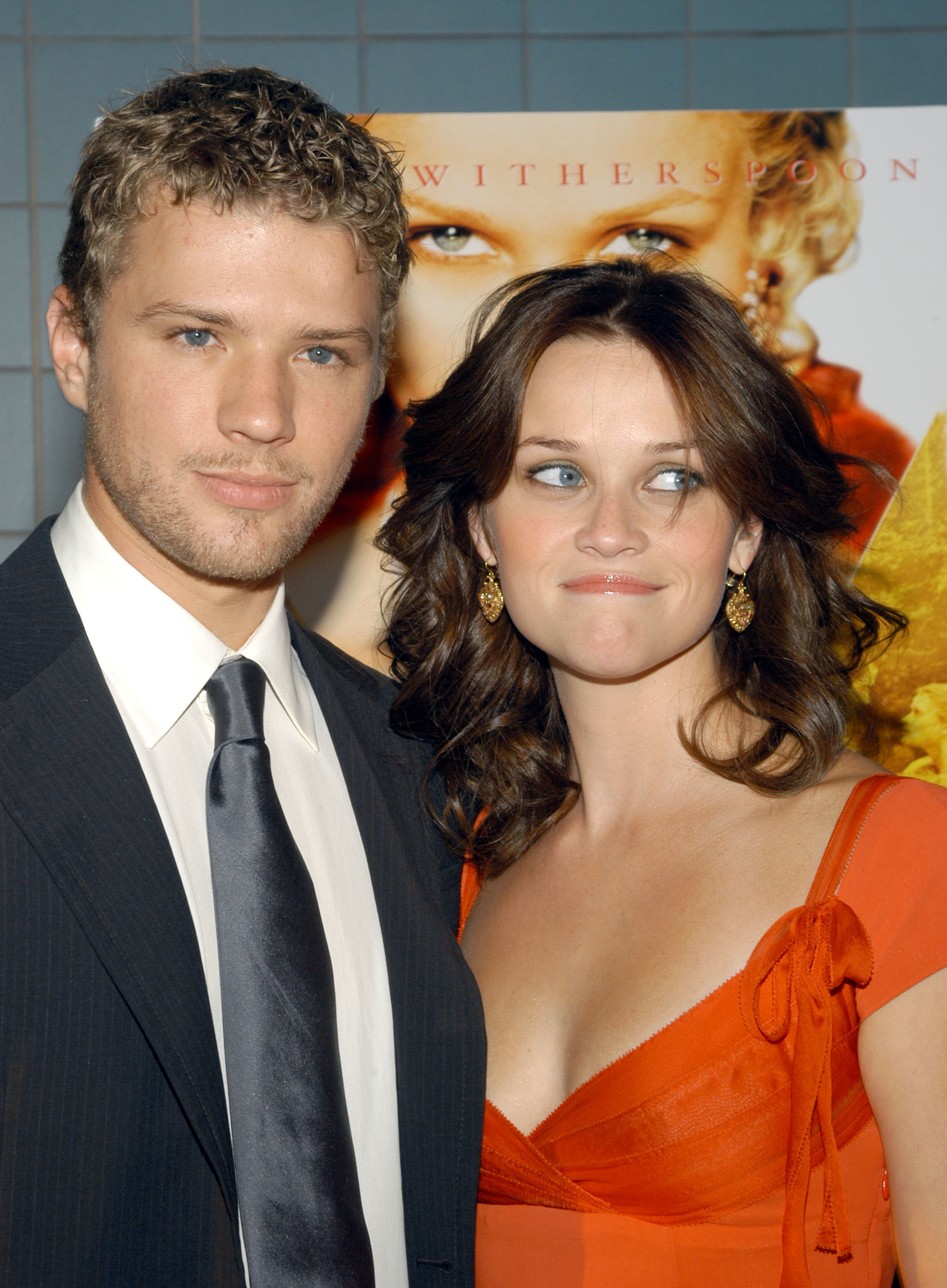 At a media event, he's in a suit and tie and she's in a short-sleeved outfit