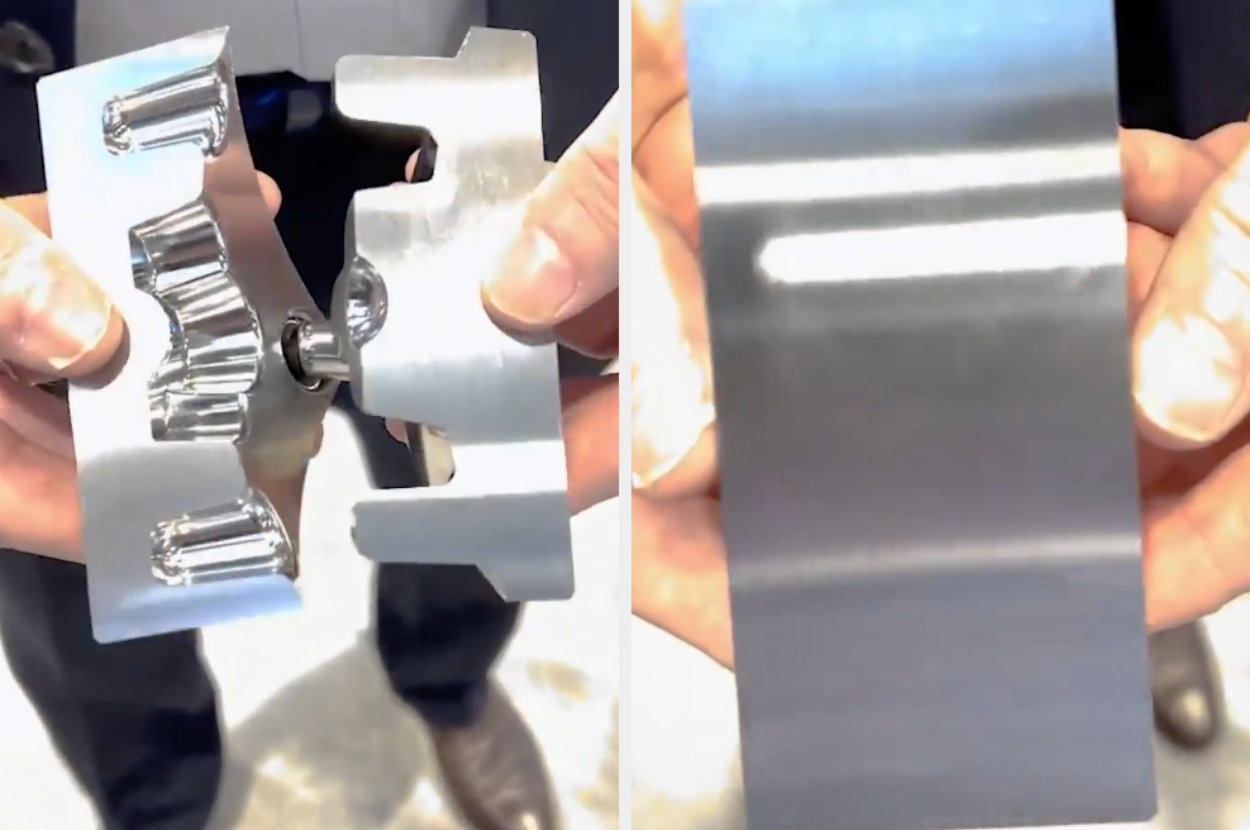 A person pulling apart a piece of metal