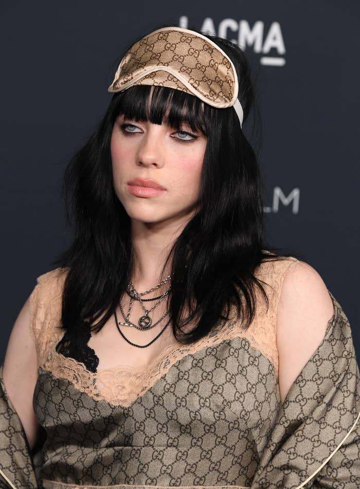 Billie at a media event in a pajama-inspired outfit complete with a sleeping mask